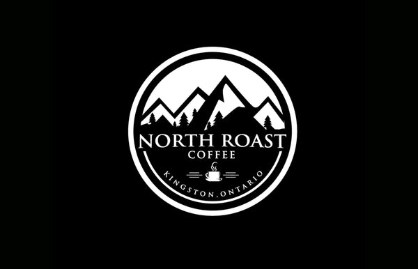 A circular north Roast coffee logo appears on a pure black background.  The north Roast logo is all black and white with graphic of mountains in the back and North Roast Coffee text overlaid.